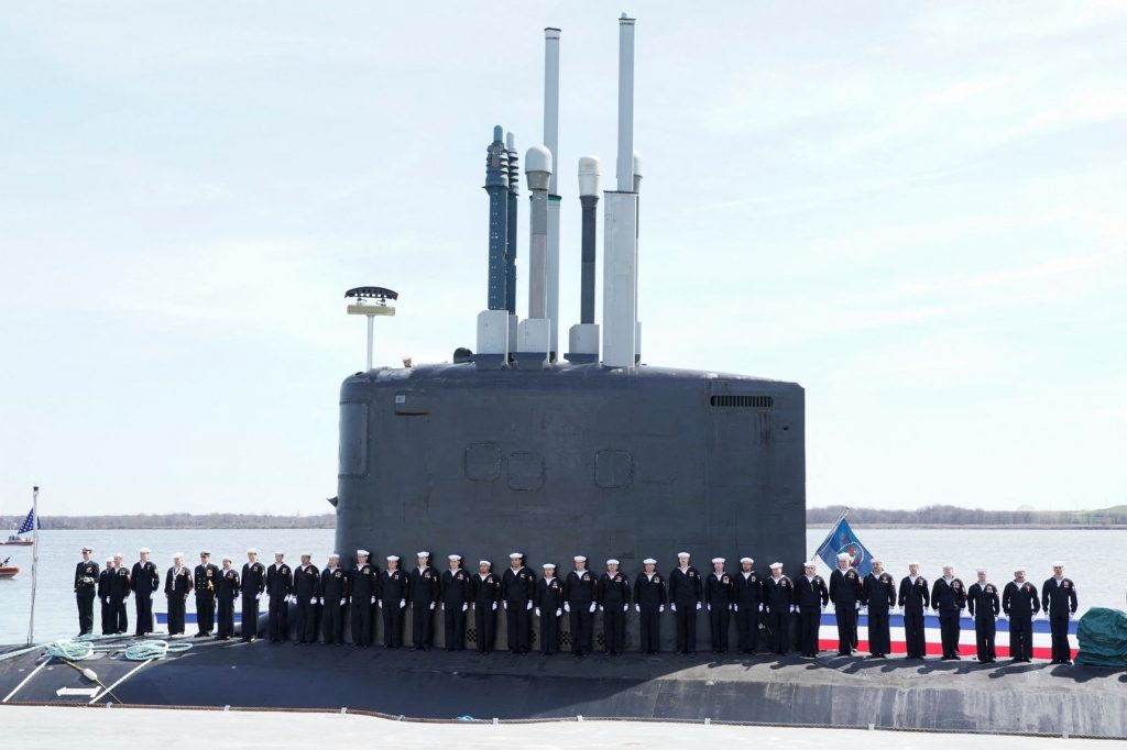Crew members board the USS Delaware nuclear submarine during a commissioning ceremony at the Port of Wilmington, Del., April 2.